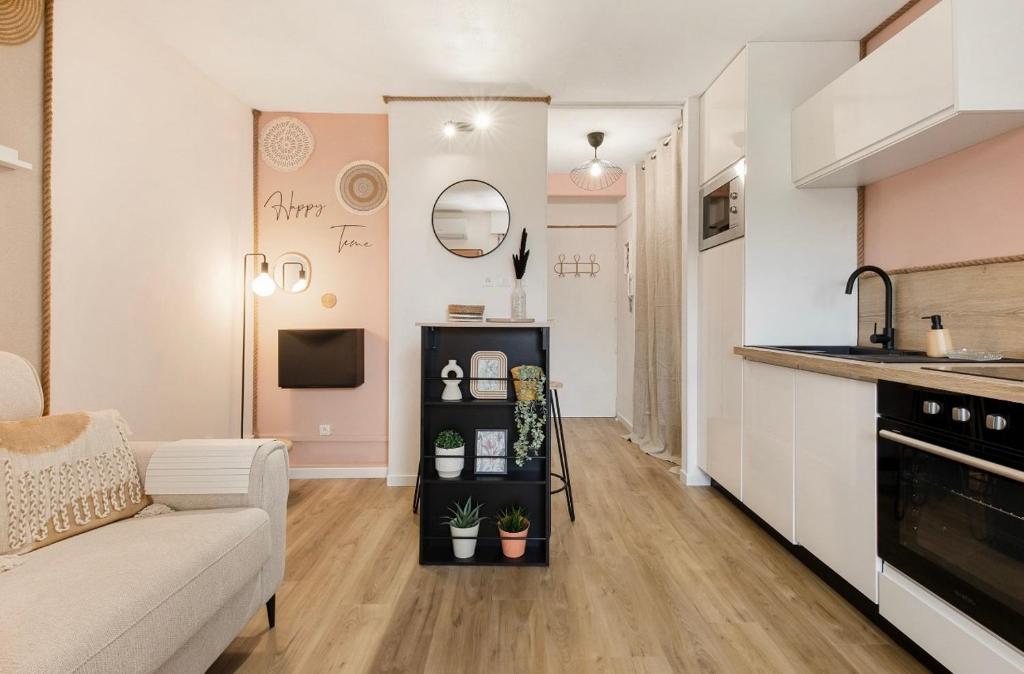 un salon avec un canapé et une cuisine dans l'établissement La perle du port, au Cap d'Agde