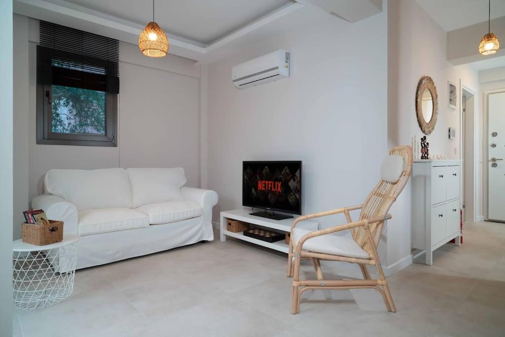 a living room with a white couch and a chair at Mama Saggio Home in Fethiye