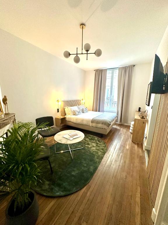 un salon avec un canapé et une table dans l'établissement So Guest, Clou dans le fer, modern suite near cathedral, à Reims