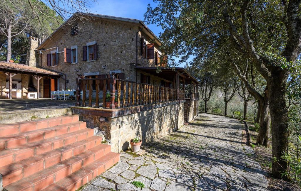 a brick house with a fence in front of it at 4 Bedroom Nice Home In Pergola in Pergola