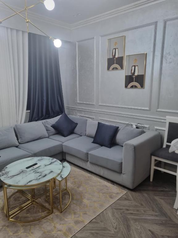 a living room with a couch and a table at Kodra e diellit residence 2 in Selitë e Vogël