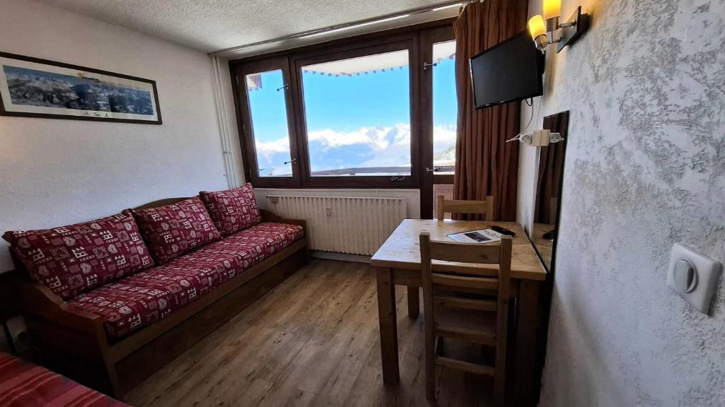 un salon avec un canapé, une table et un bureau dans l'établissement Résidence Le France - Studio 2 personnes Plagne Centre MAE-2804, à Aime La Plagne