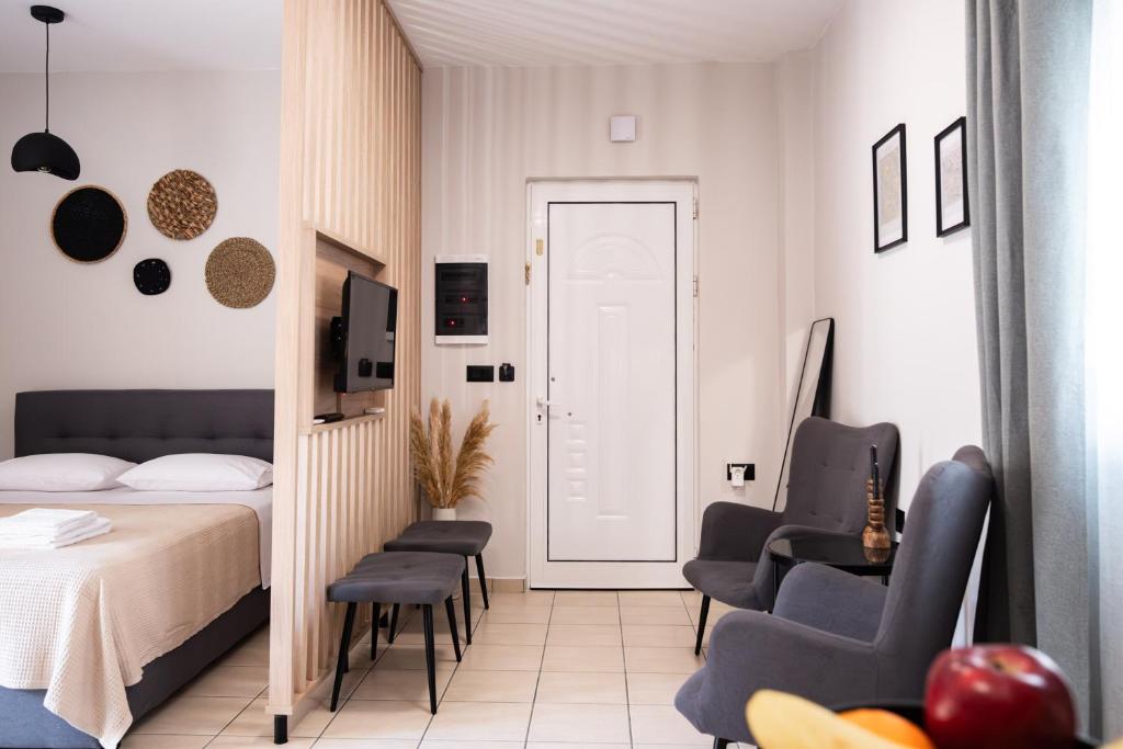 una camera con un letto e due sedie e una porta di Nektaria Studio a Chania