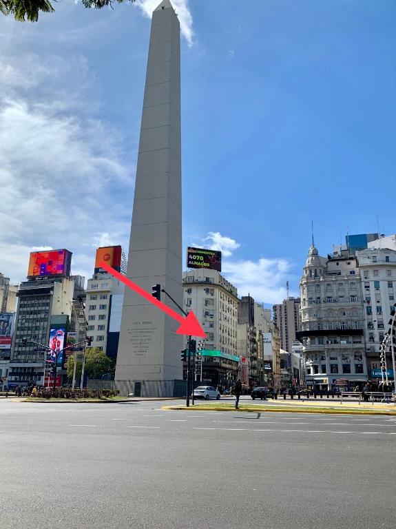 a large obelisk in the middle of a city at Corazón obelisco 4 in Buenos Aires