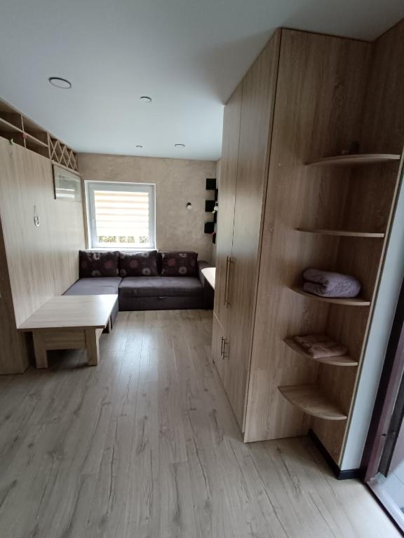 a living room with a couch and a table at Laisvas kambarys in Svėdasai