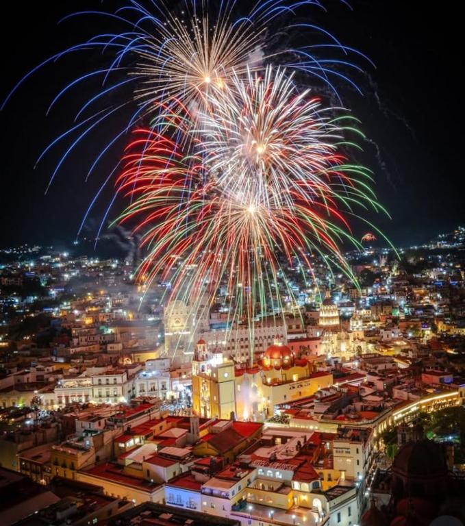 a fireworks display over a city at night at Loft en Casa Jasso! in Guanajuato