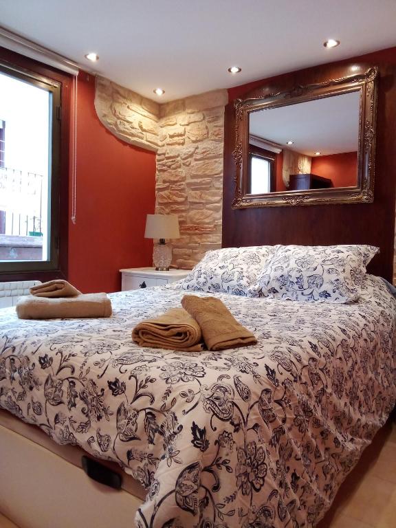 a bedroom with a bed and a mirror at Errotaetxe Mundaka in Mundaka