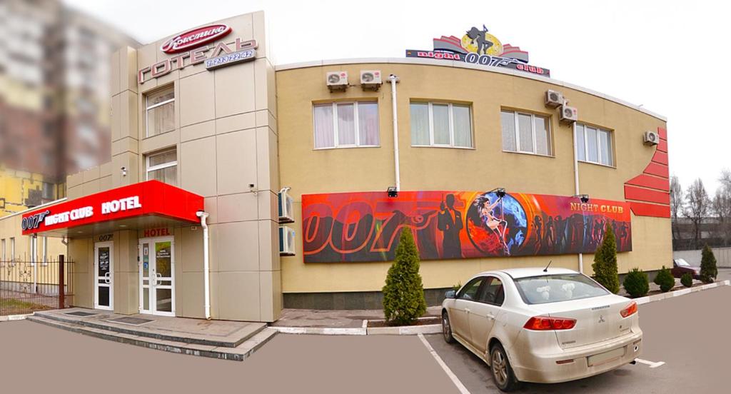 a building with a car parked in front of it at Kristina Hotel in Zaporozhye