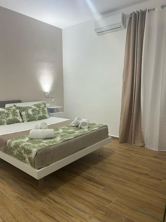 a bedroom with a bed with towels on it at La dimora degli scrittori in Porto Empedocle