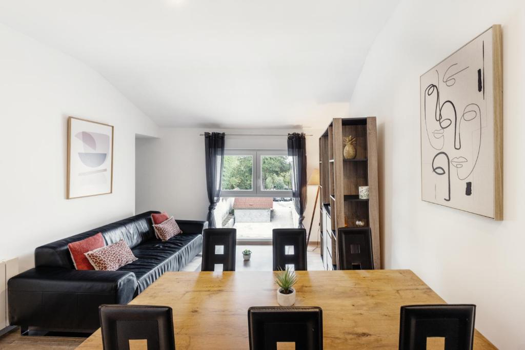 un salon avec une table et un canapé dans l'établissement 2 chambres, hyper-centre, stationnement privé gratuit, à Bourg-en-Bresse