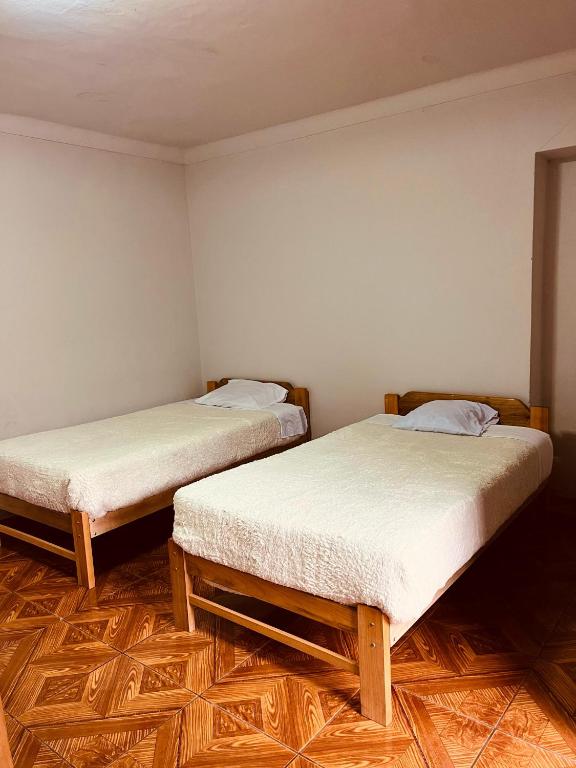 Postel nebo postele na pokoji v ubytování hostel arcoiris urubamba
