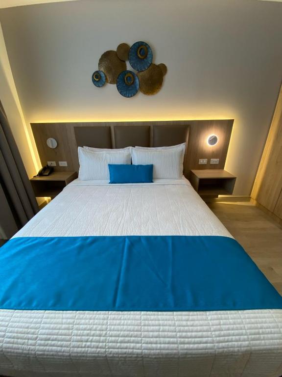 Postel nebo postele na pokoji v ubytování Hotel Cumbayá Sanvy