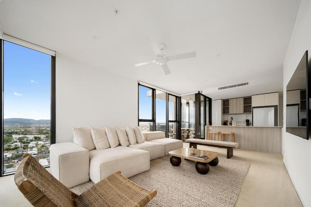 a living room with a white couch and a table at Seren - Luxury Ocean Views With Pool And Gym in Gold Coast