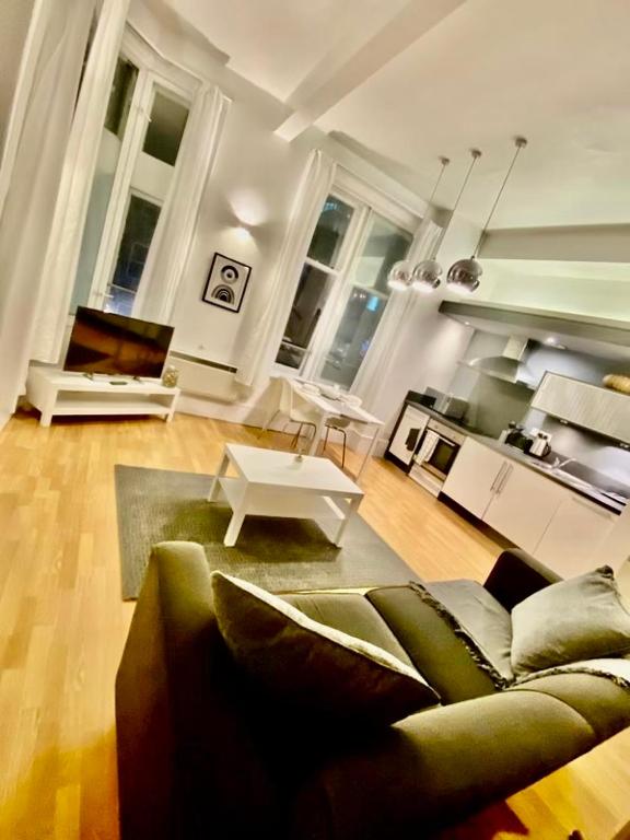 a living room with a couch and a table at Cozy Studio Apartment in Leeds