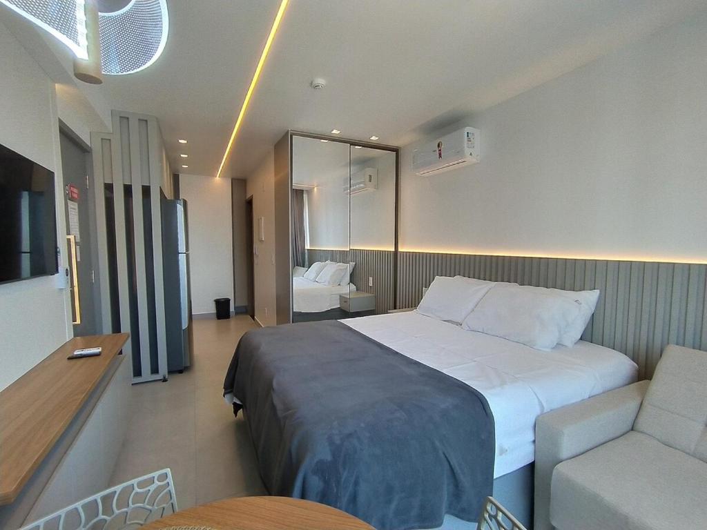 a bedroom with a bed and a couch and a chair at Studio Manaíra #SSR802 Prox Shop in João Pessoa