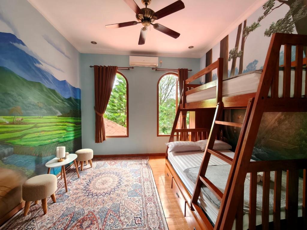 a bedroom with bunk beds and a ceiling fan at Wonderful Villa Felice in Yogyakarta