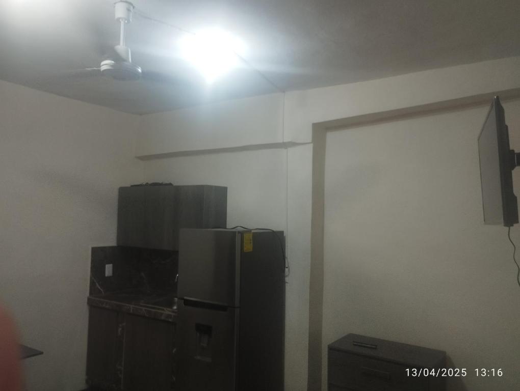 a room with a refrigerator and a light on the ceiling at Depa in Mazatlán