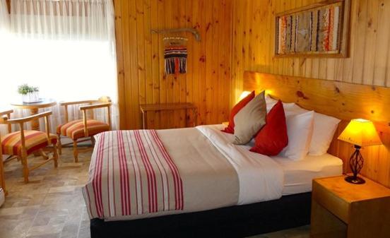 Postel nebo postele na pokoji v ubytování Hotel del Paine