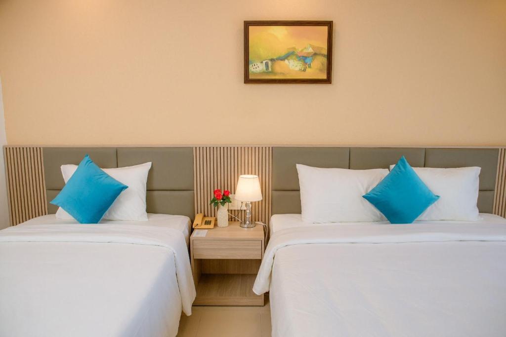 Giường trong phòng chung tại Lanxy Hotel Nha Trang