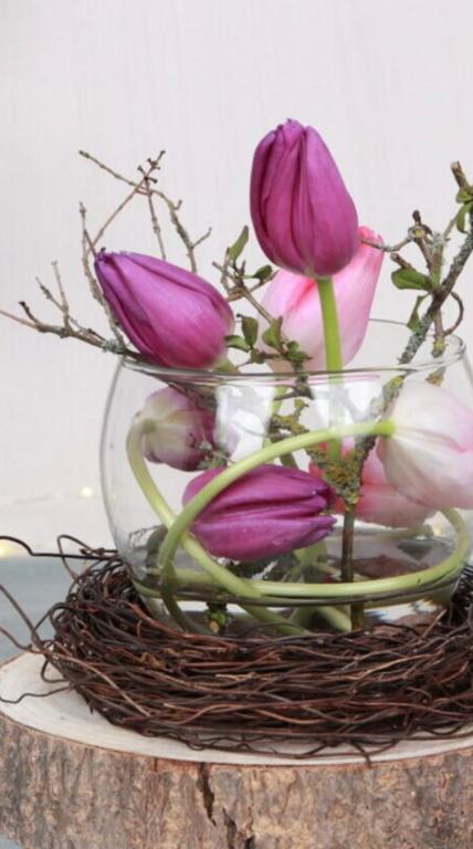 a vase filled with purple flowers in a nest at Aydogan Vermietung in Stade