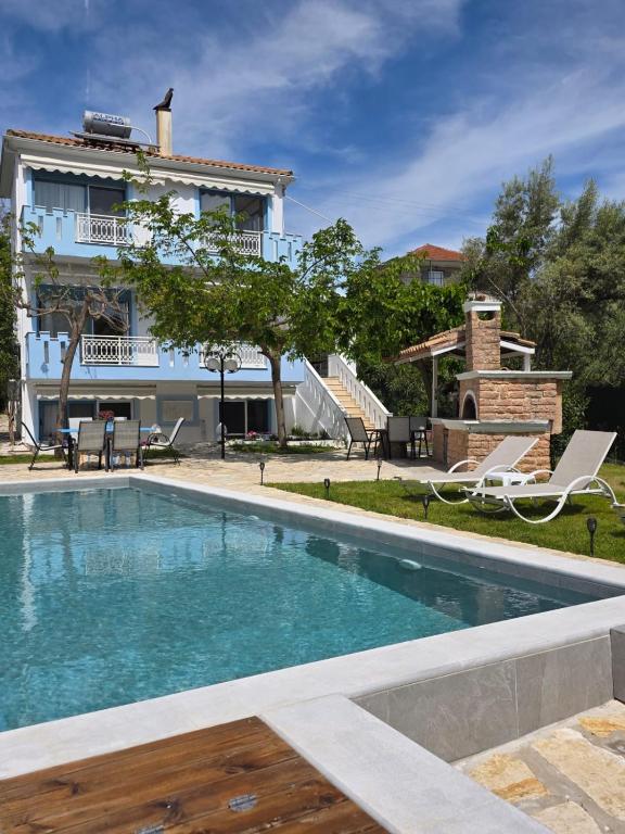 a swimming pool in front of a building at Villa Garden and Sea Lefkada in Lygia
