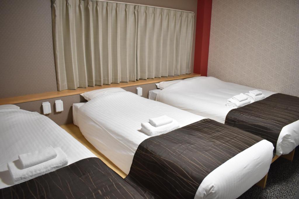 Postel nebo postele na pokoji v ubytování Shinsaibashi House