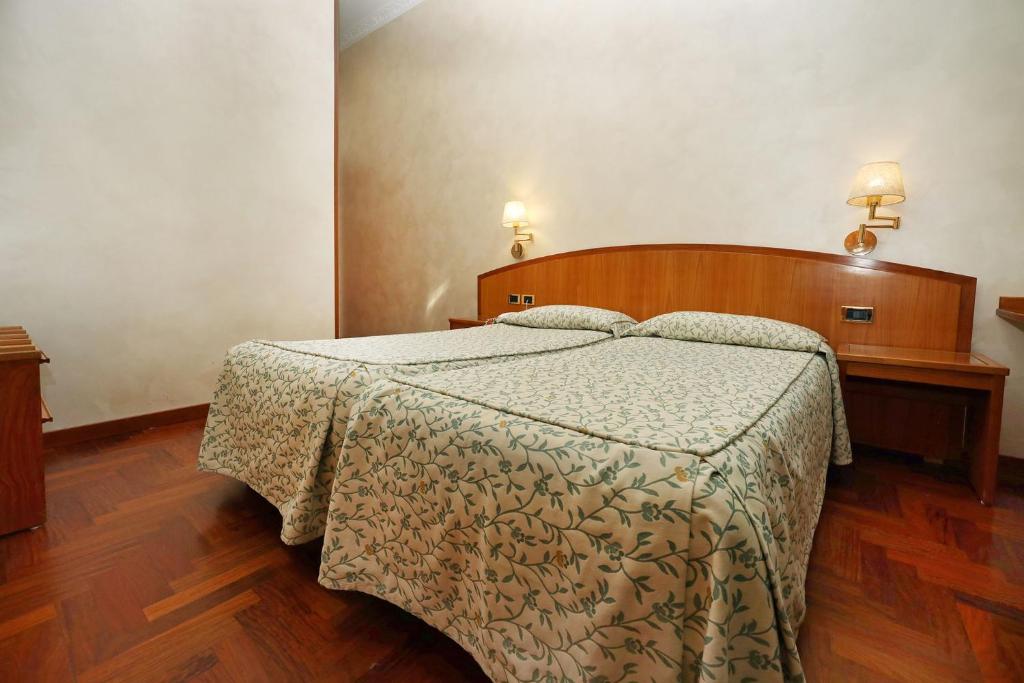 Postel nebo postele na pokoji v ubytování Hotel Corot