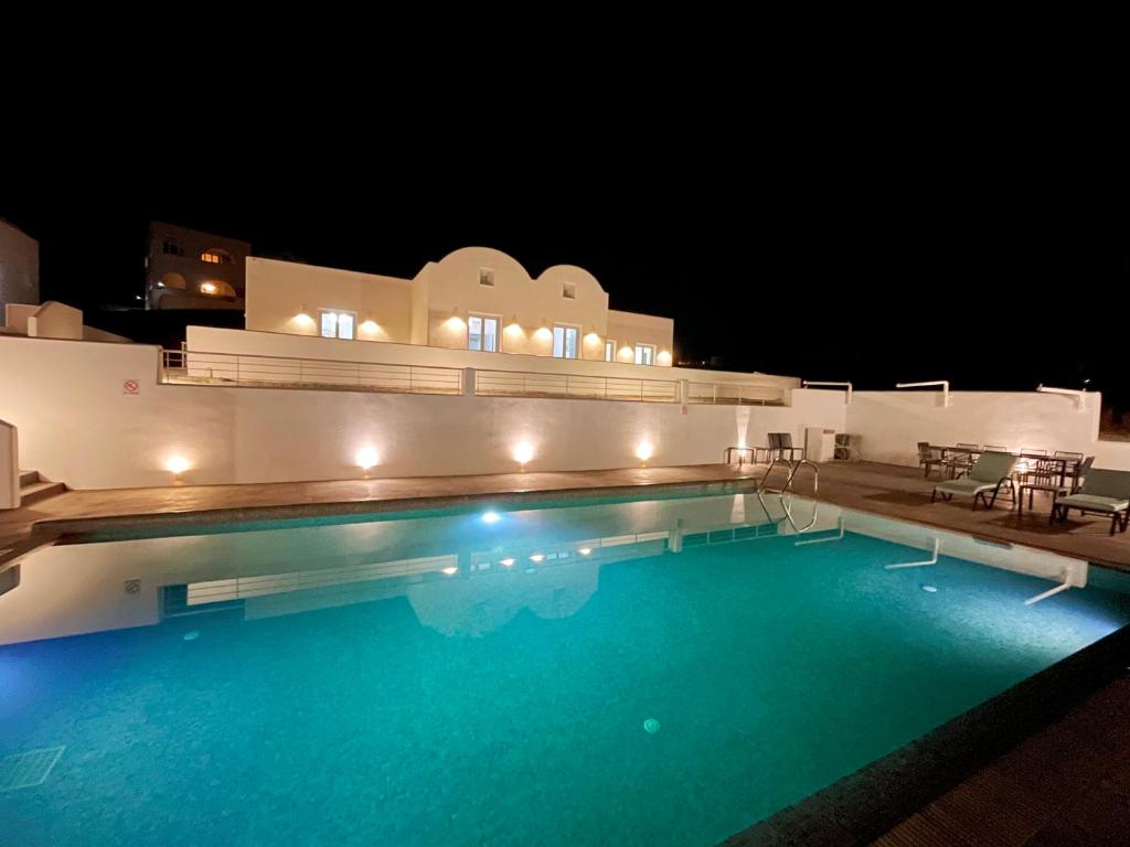 a large swimming pool at night with lights on it at SEA villa in Monolithos