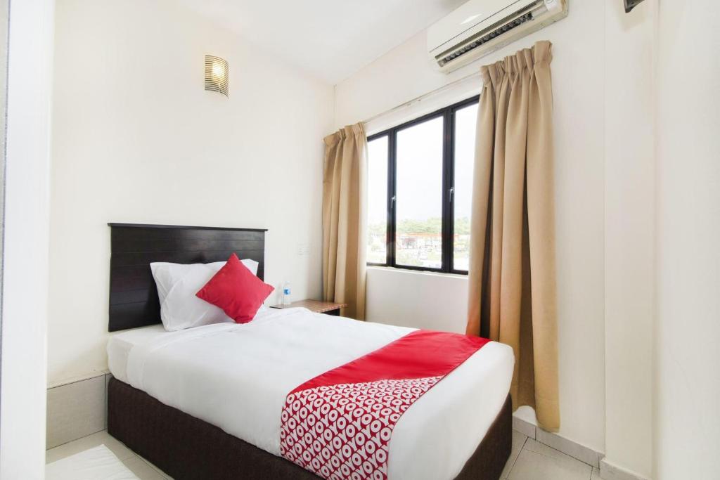 a bedroom with a bed and a large window at Hotel O 91 @ Bukit Mewah in Kajang