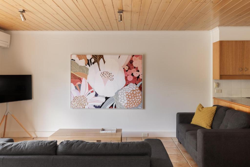 a living room with a couch and a painting on the wall at Cora Lynn - Apartment 3 in Lorne