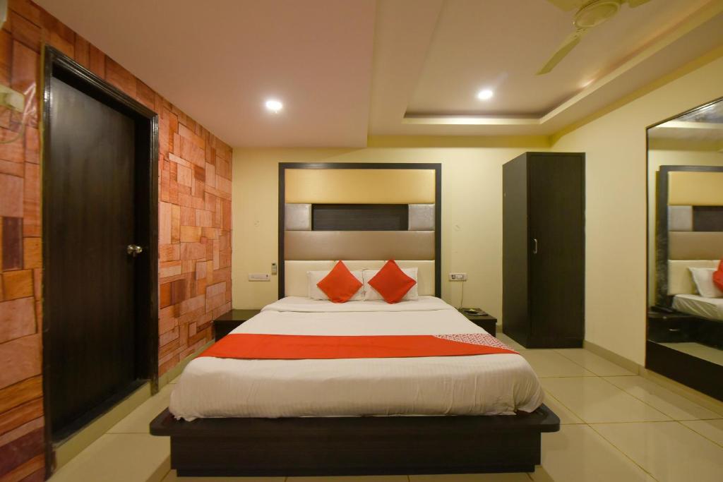 a bedroom with a large bed with red pillows at Collection O Tip Top in Jaipur