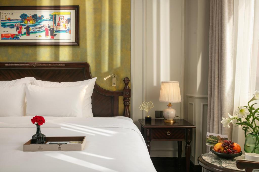 Postel nebo postele na pokoji v ubytování La Mejor Indochine Hotel