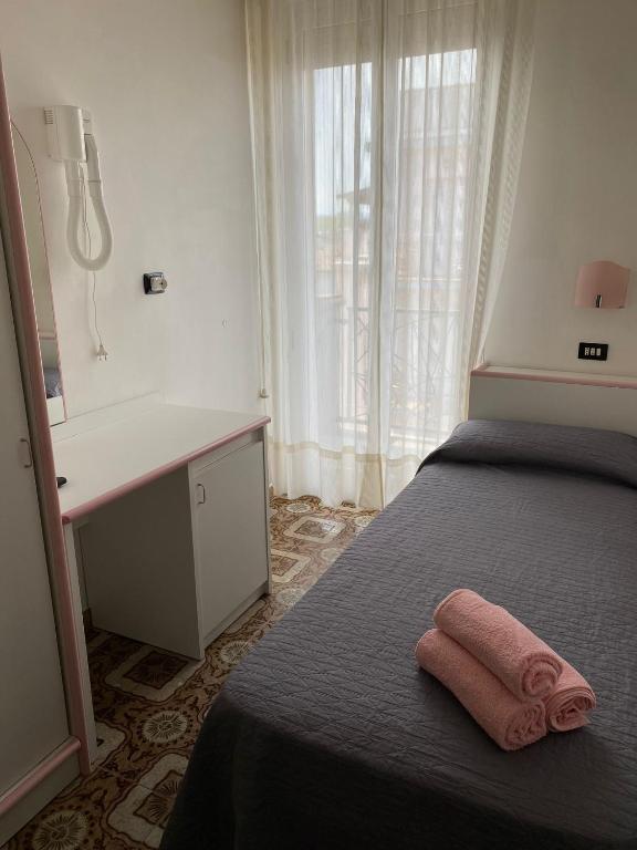 Postel nebo postele na pokoji v ubytování Hotel Rosy