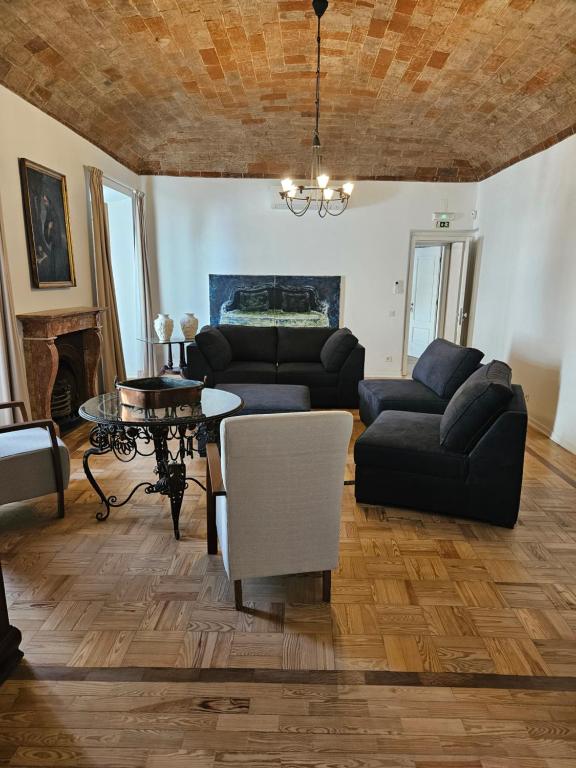 a living room with two couches and a table at Solar de Arrayollos by PURUS in Arraiolos