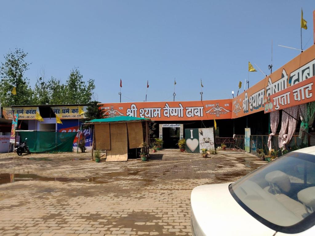 a car parked in front of a building at Shree shyam vashno in Jāmb