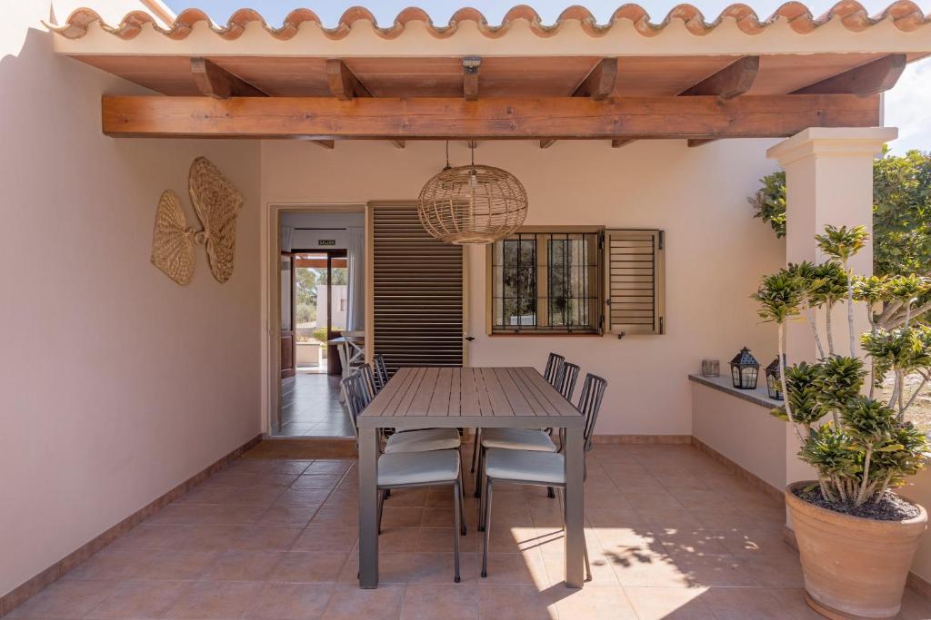 a patio with a wooden table and chairs at Ca N'Alicia Des Bosch in Illes Balears
