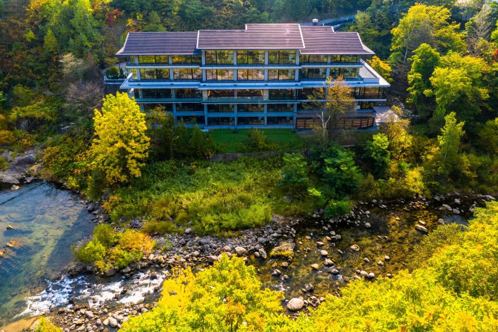 an aerial view of a building next to a river at Chalet Ivy Jozankei in Jozankei