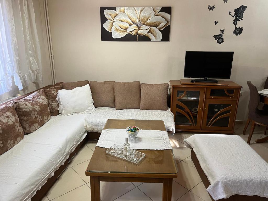 a living room with a couch and a tv at Dora's House in Panayia