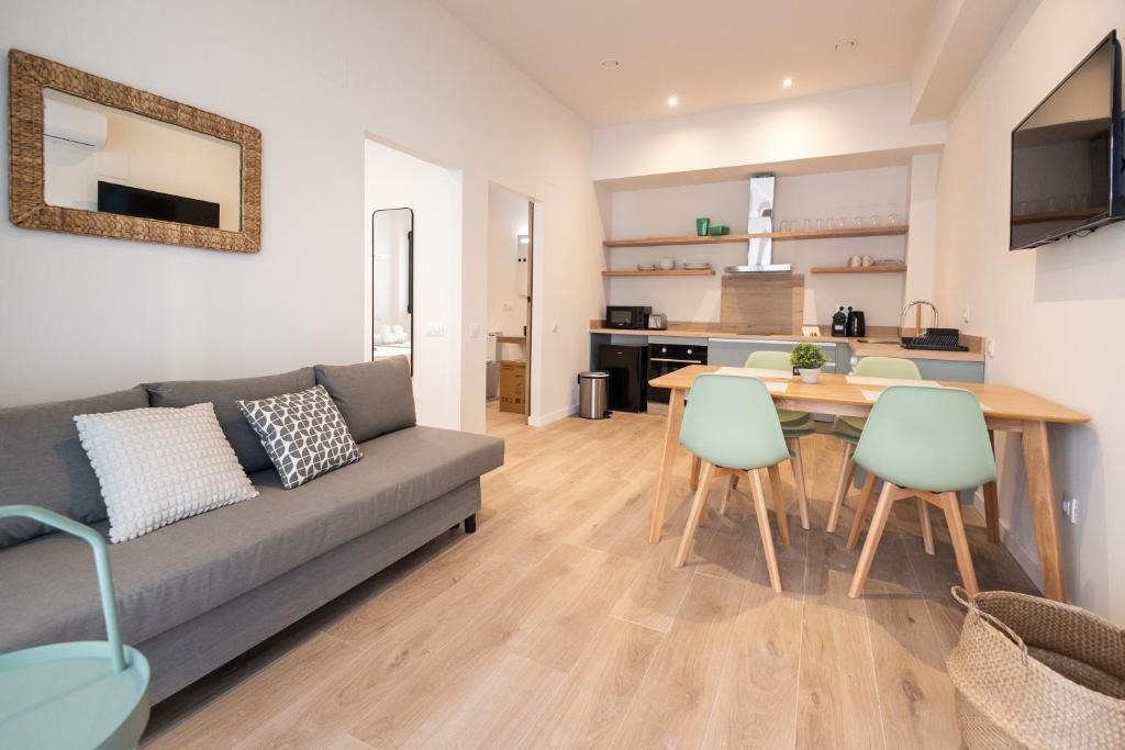 a living room with a couch and a table and chairs at Lisboa by Concept Flats in Valencia