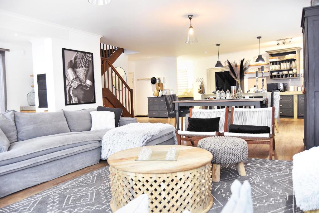 a living room with a couch and a table at 4on Pebbles Holiday Home in Swakopmund
