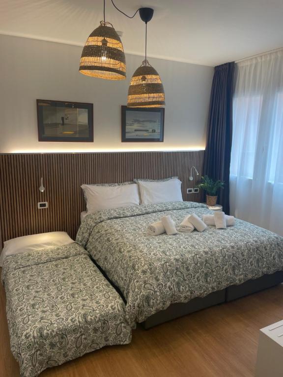 A bed or beds in a room at Hotel La Pergola di Venezia
