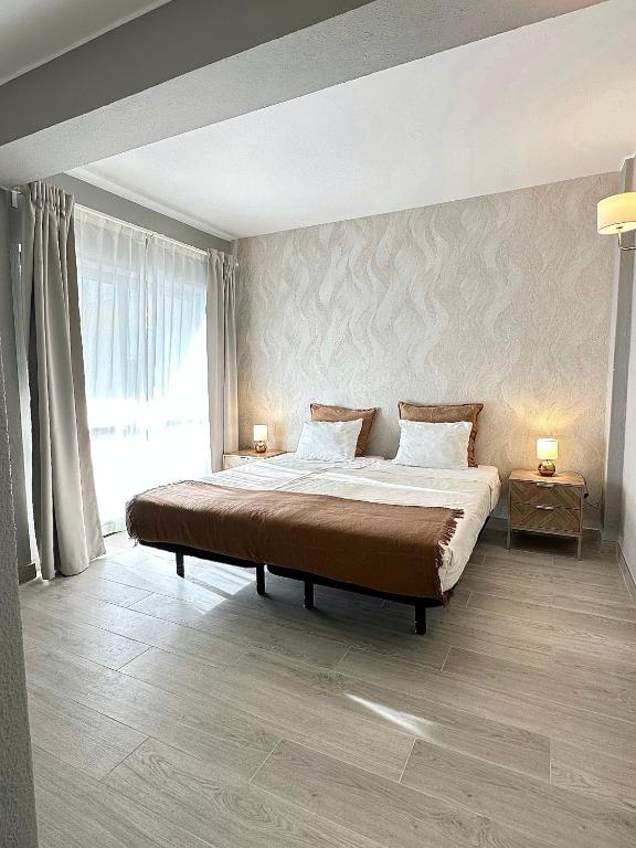 a bedroom with a large bed and a large window at DonAna 308 in Lagos