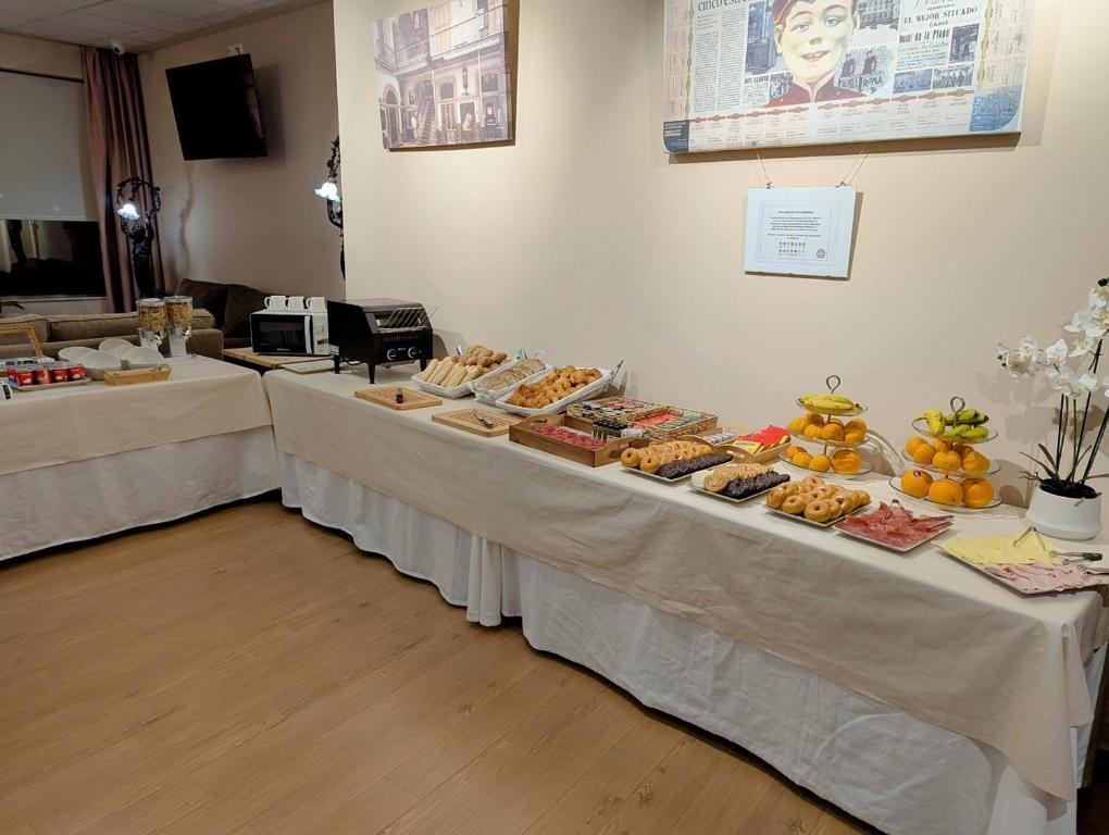 two tables with food on them in a room at Hotel de Francia y París in Cádiz