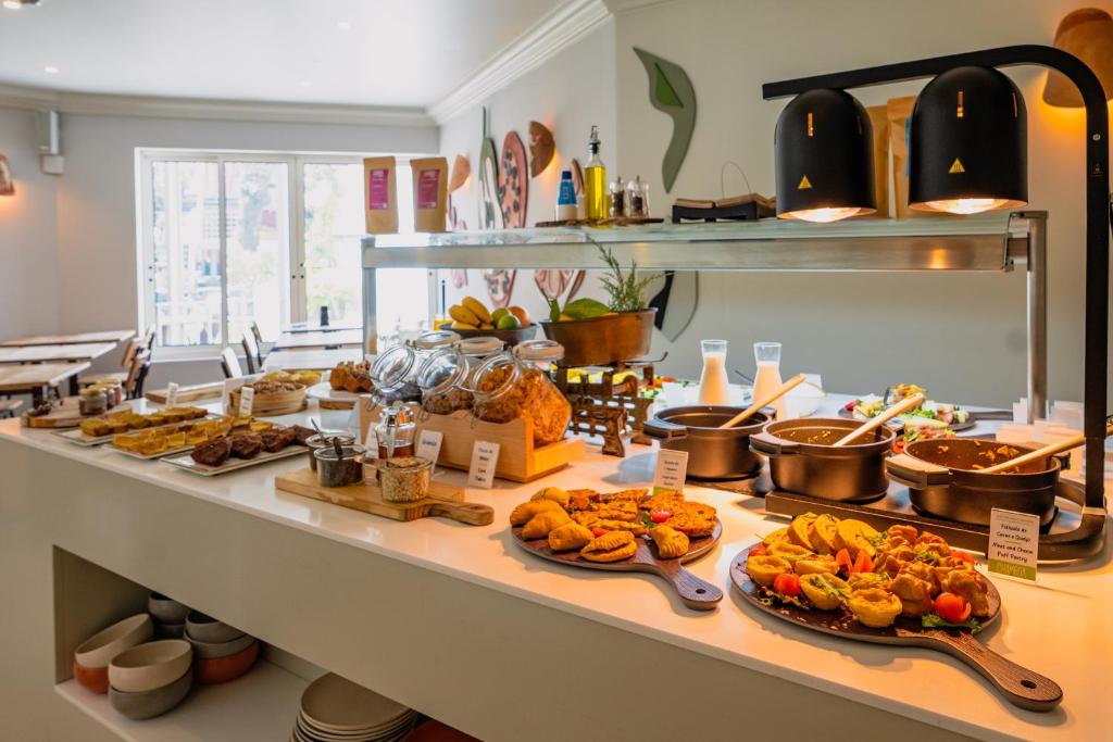 A broad breakfast buffet offering pastries, fruit, hot dishes and drinks.