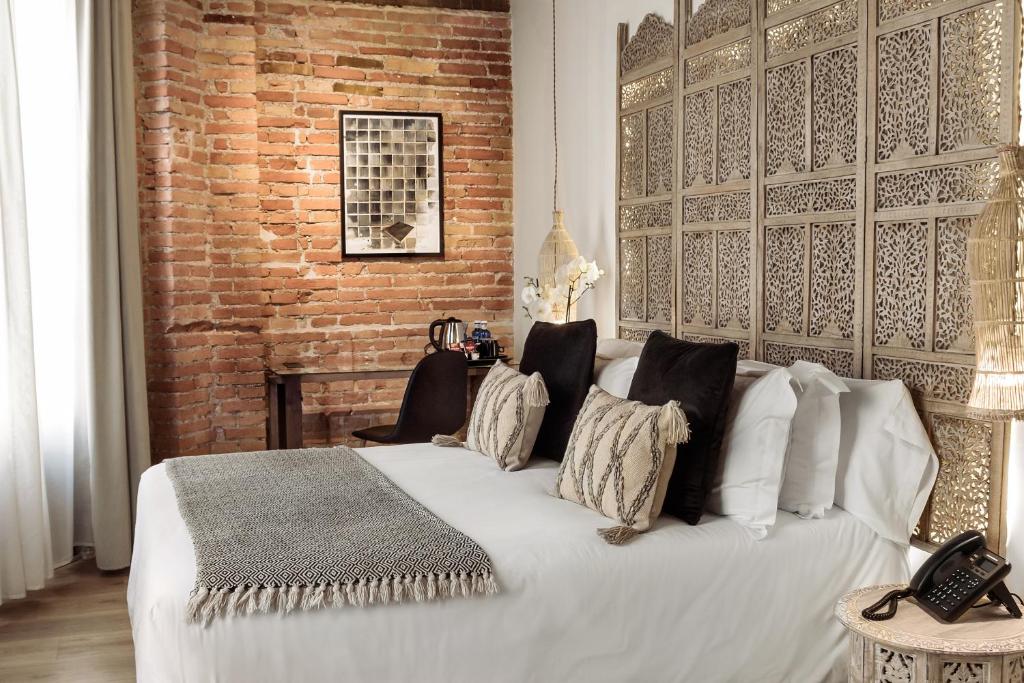Postel nebo postele na pokoji v ubytování Hotel La Casa de Los Mosaicos