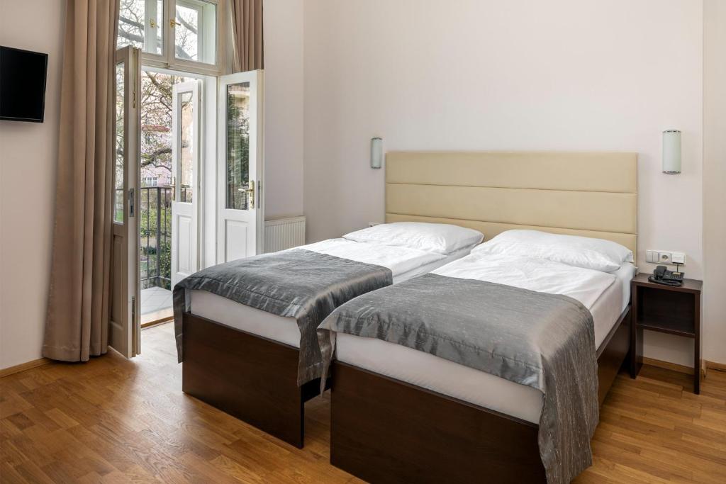 Postel nebo postele na pokoji v ubytování Hotel Unique