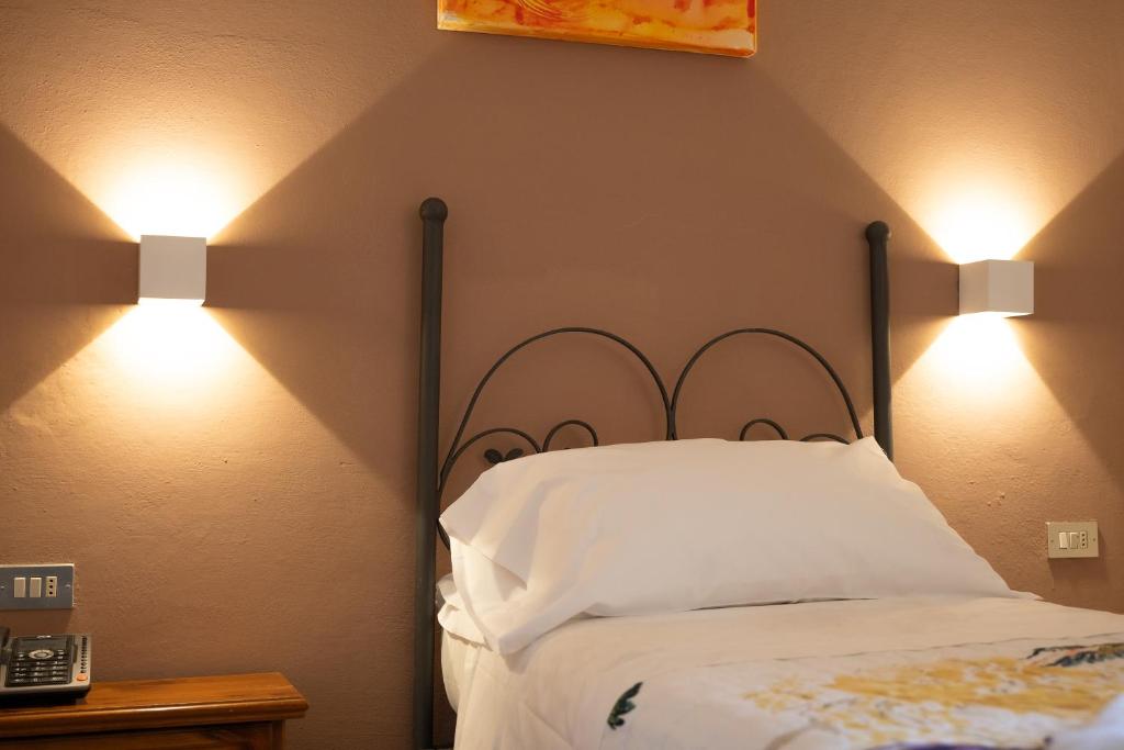 Postel nebo postele na pokoji v ubytování Albergo Del Chianti