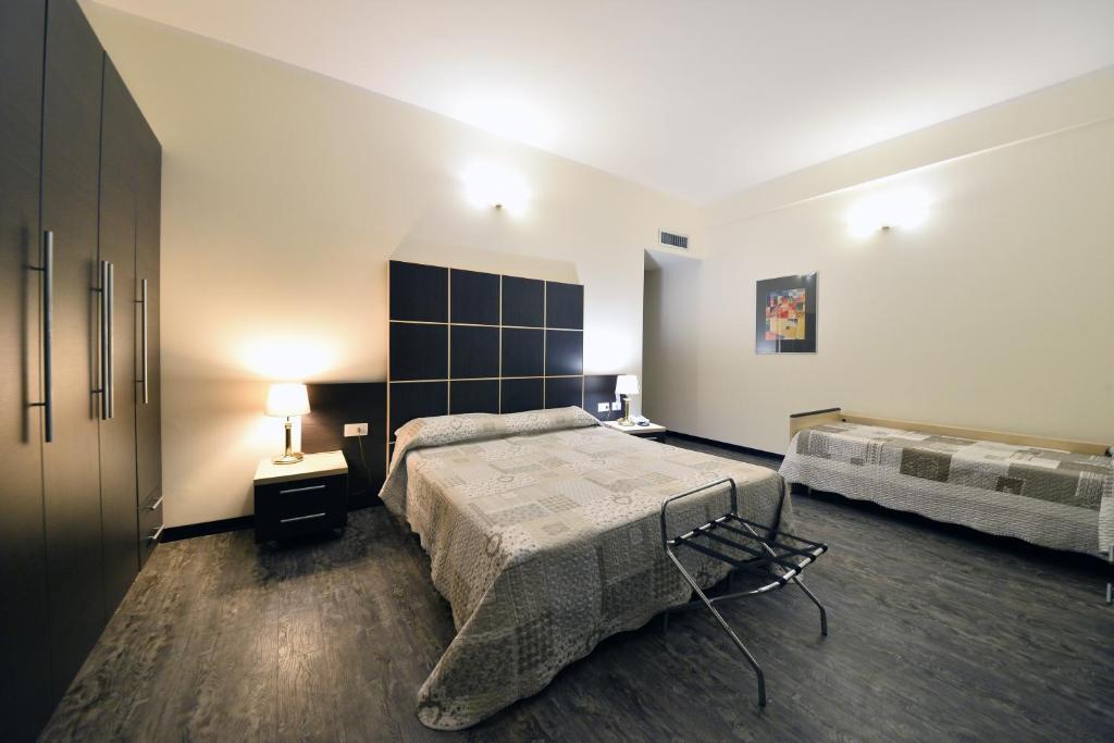 Postel nebo postele na pokoji v ubytování Hotel Ferrari