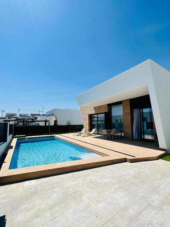 a swimming pool in front of a house at Villa NewRay in Finestrat