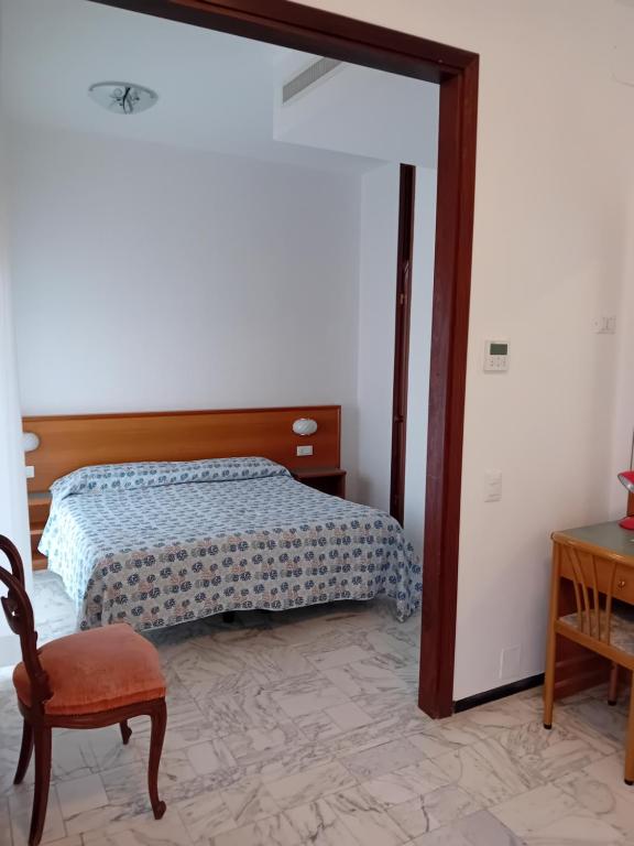 Postel nebo postele na pokoji v ubytování Hotel Valentino